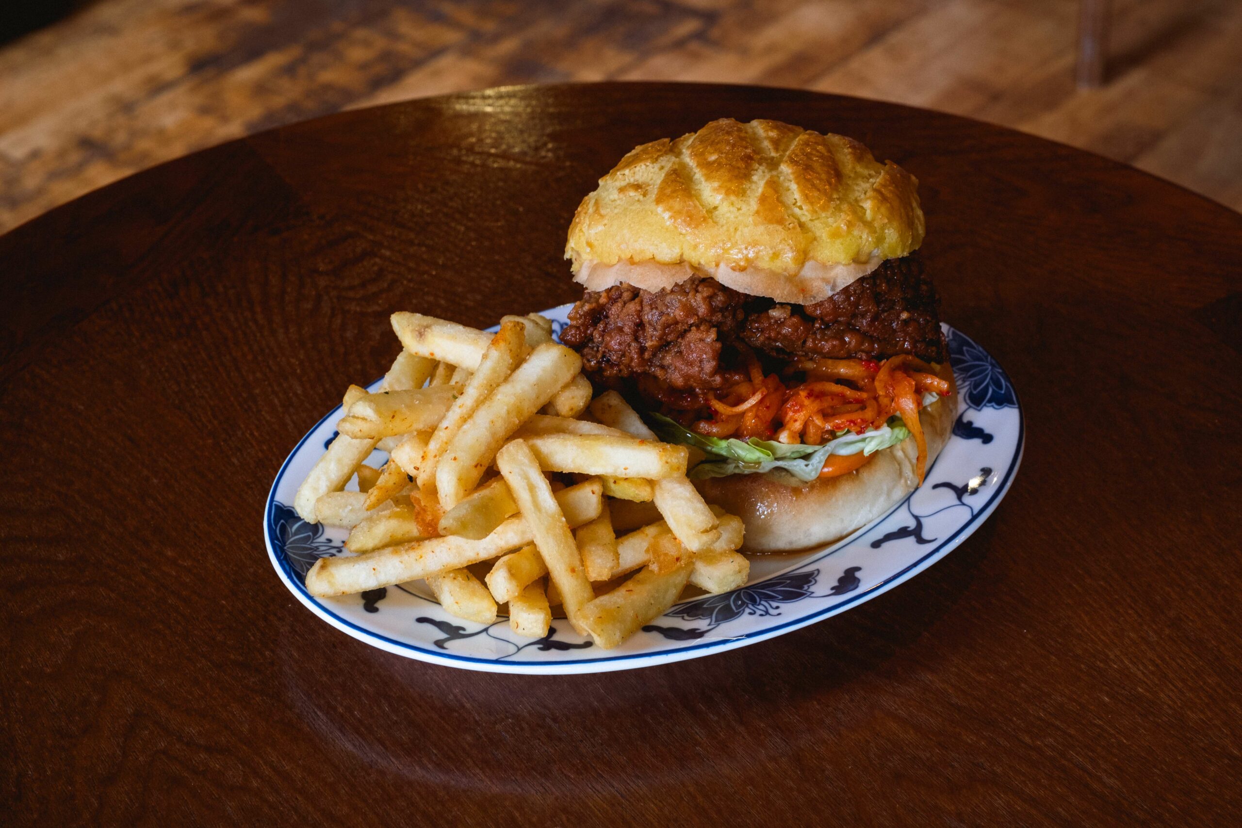 ANDO1596 Pomelo's hot honey chicken sandwich on a pineapple bun